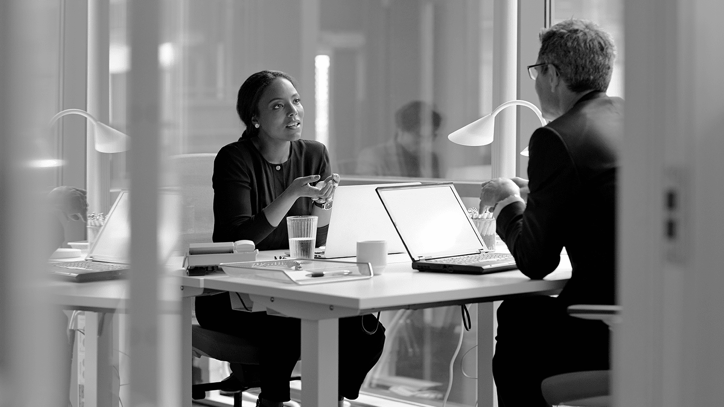 Man and a woman discussing in an office